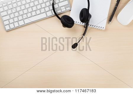 Office desk with headset and supplies. Call center table. Top veiw with copy space