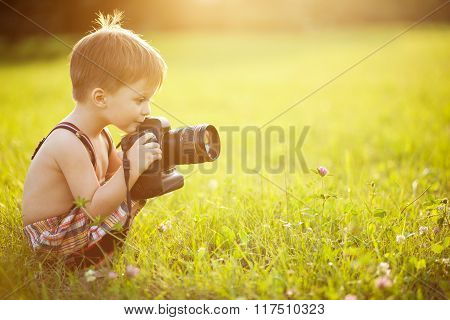 Sunny portrait of child with camera