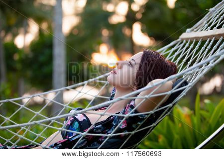 Woman Relaxing In A Hammock
