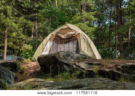 Great gorgeous closeup view of cozy inviting camp tent in pine trees forest