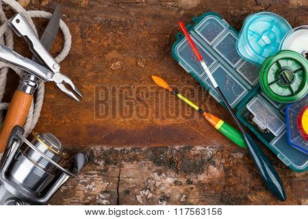 Fishing Tackles For Anglers On Wooden Background