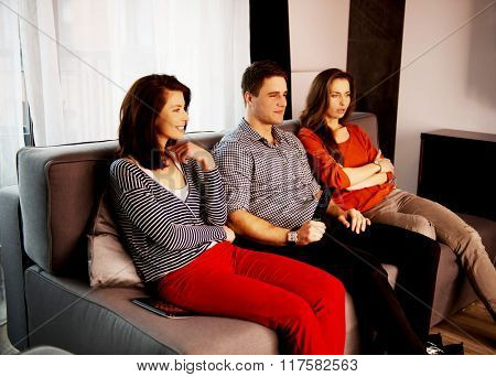 Sisters and brother relaxing at home.