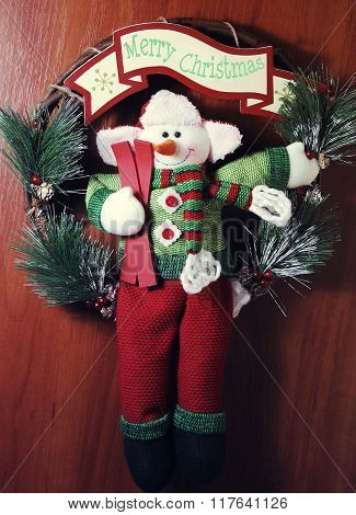Funny snowman with text Merry Chrictmas on wooden background