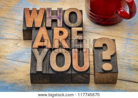 Who are you question in vintage letterpress wood type printing blocks with a cup of coffee