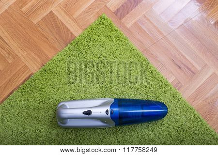 Handheld Vacuum Cleaner On The Carpet