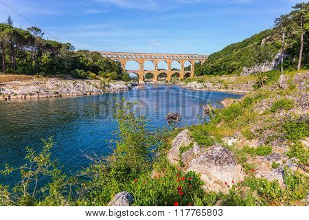 Three-tiered aqueduct Pont du Gard - the highest in Europe.  Provence, spring sunny day. The bridge was built in Roman times on the river Gardon