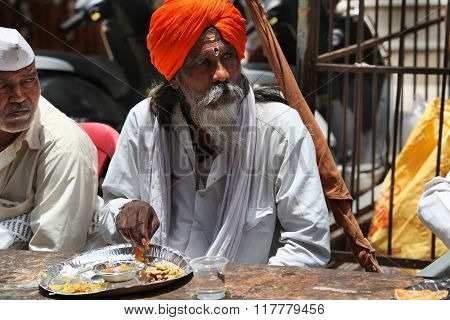 Pune, India  - july 11, 2015: A Hindu Pilgrim Having A Meal Served To Him By A Charitable Organiza