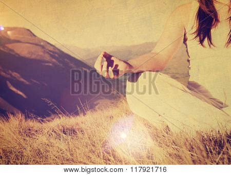 Lady meditating in lotus position on top of the mountain Concept
