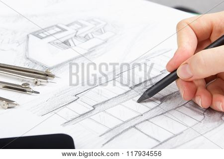 Architect working on blueprint. Architects workplace - architectural project, blueprints, ruler, cal