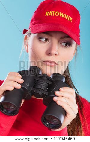 Lifeguard On Duty Supervising With Binoculars.
