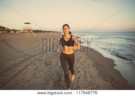 Beautiful fit female fitness woman training and working out outside in summer