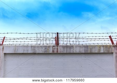 Barbed Wire Wall On Blue Sky
