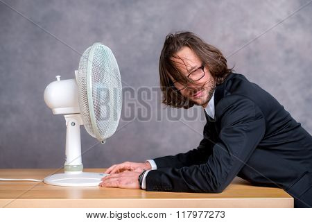 Business Man In Dark Suit Sitting In Front Of Ventilator