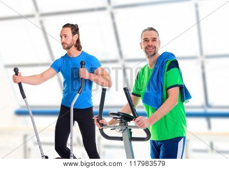 Two Young Man Train With Fitness Machine