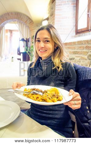 Young Woman Italian Restaurant Shows  Serving Tray Full Of Steaming Pasta