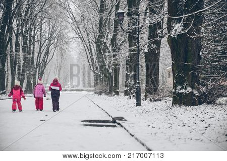 group of kids playing outside in snowy winter day