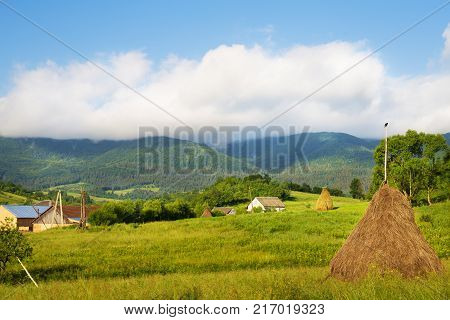Haystack summer in the beautiful village Ukrainian Carpathians