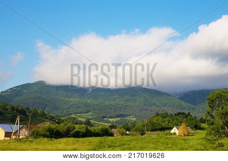 Haystack summer in the beautiful village Ukrainian Carpathians
