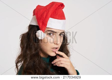 beautiful woman holds a hand near the lips, portrait, new year, winter.
