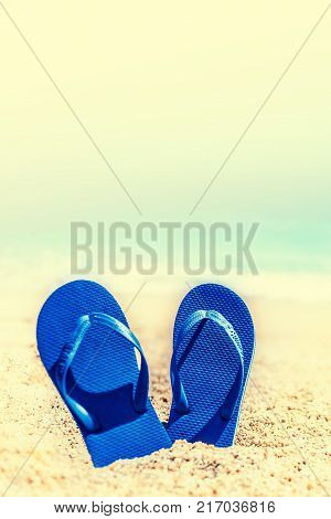 Summer Holidays in Beach Seashore. Summer vacation concept in vintage hipster style with blue flip flops