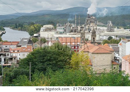 PONTECESURES, SPAIN -SEPTEMBER 10, 2017: Cityscape of Pontecesures with old church and large factory on the Camino de Santiago trail on September 10, 2017 in Galicia, Spain
