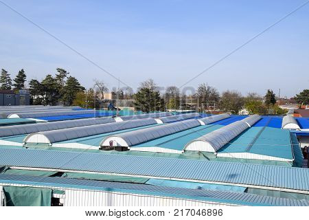 Covered Market In The City. Rows Of Sales Outlets. View From The Bridge To The City Market.