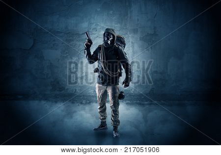 Big peril men in front of a crumbly wall with dangerous stuffs in his hand