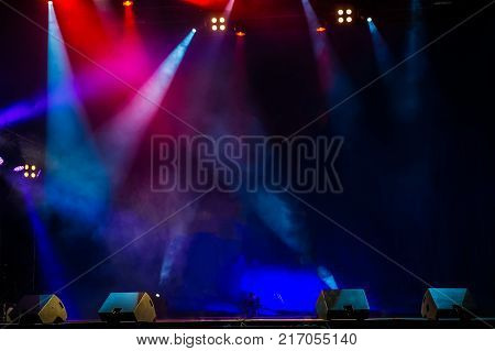Concert stage. Beautiful Colourful disco lighting in the stage. Performance moving lighting. Concert Light Show. Stage Lights.