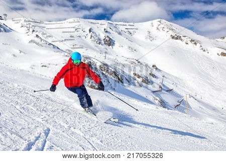 Man skiing on the prepared with fresh new powder snow in Tyrolian Alps Zillertal Austria