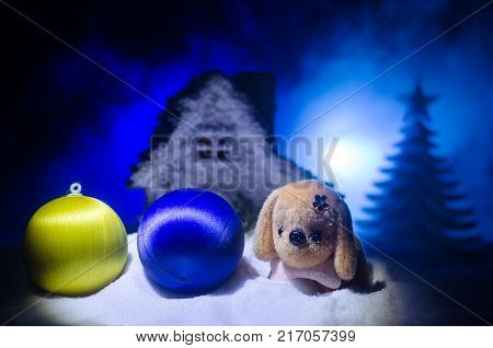 Toy Dog - A Symbol Of The New Year Under The Snow Against The Background Of Fir Branches. Toy's Dog 