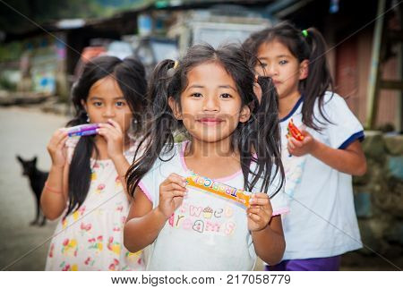 BATAD, PHILIPPINES-MARCH 31, 2016: Local children with sweets portrait in Batad on March 31, 2016.  Philippines.