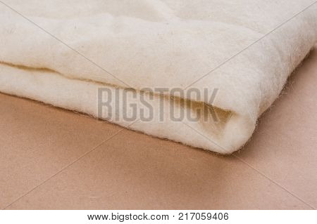 White background of non-woven natural woolen material
