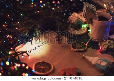 Letter for Santa on decorated chrismas background with gingerbread coocies and garland