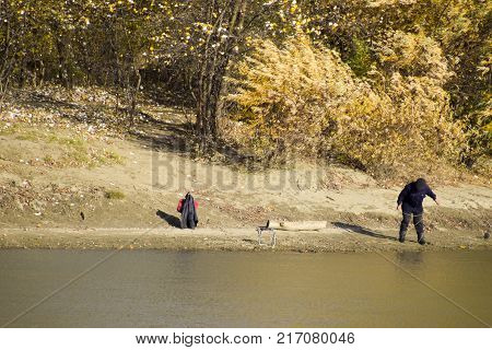 Fishermen On The Bank Of The River In Autumn. Fishing The Bait.