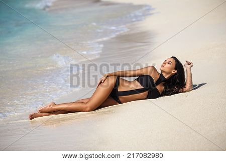 Beautiful young girl in a sexy bikini on the beach
