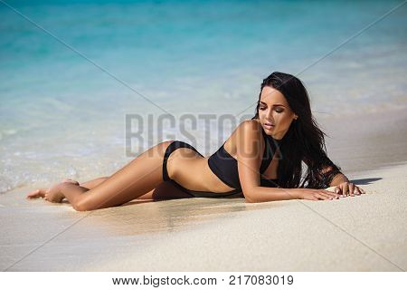 Beautiful young girl in a sexy bikini on the beach