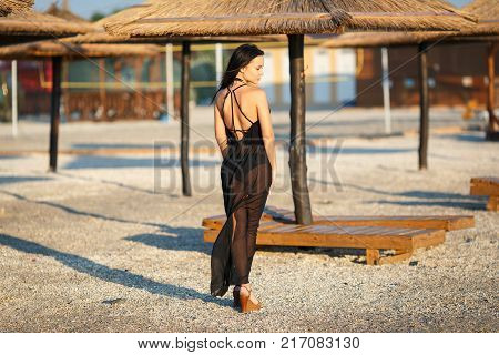 Beautiful young girl in a sexy black swimsuit