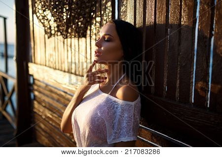 Beautiful young girl portrait in fashion style on sunset