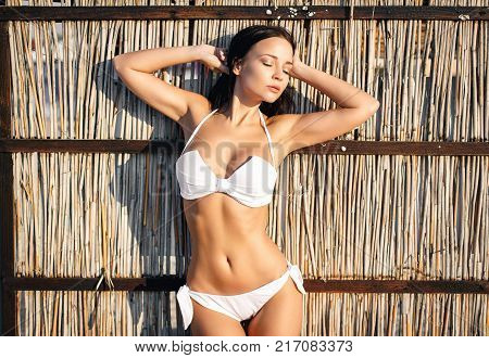 Beautiful young woman in a sexy white bikini