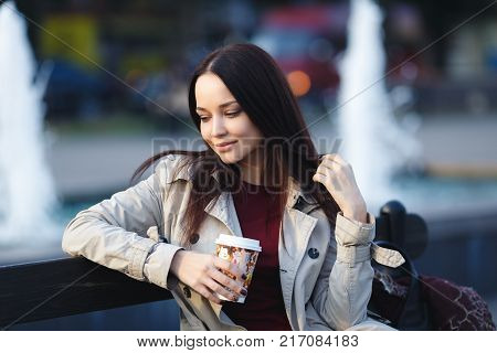 Beautiful young girl with cup of coffee