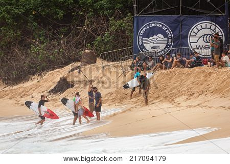 SUNSET BEACH HAWAII USA - DECEMBER 2, 2017: Competitive surfers being congratulated on the beach at the 2017 Vans World Cup of Surfing competition at Sunset Beach on Oahu's scenic North Shore. This is the second of three surfing competitions and Conner Co