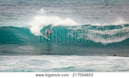 SUNSET BEACH HAWAII USA - DECEMBER 2, 2017: Competitive surfer at the 2017 Vans World Cup of Surfing competition at Sunset Beach on Oahu's scenic North Shore. This is the second of three surfing competitions and Conner Coffin took first place.