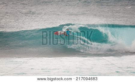SUNSET BEACH HAWAII USA - DECEMBER 2, 2017: Competitive surfer at the 2017 Vans World Cup of Surfing competition at Sunset Beach on Oahu's scenic North Shore. This is the second of three surfing competitions and Conner Coffin took first place.