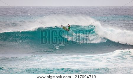 SUNSET BEACH HAWAII USA - DECEMBER 2, 2017: Competitive surfer at the 2017 Vans World Cup of Surfing competition at Sunset Beach on Oahu's scenic North Shore. This is the second of three surfing competitions and Conner Coffin took first place.
