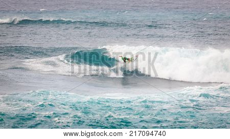 SUNSET BEACH HAWAII USA - DECEMBER 2, 2017: Competitive surfer at the 2017 Vans World Cup of Surfing competition at Sunset Beach on Oahu's scenic North Shore. This is the second of three surfing competitions and Conner Coffin took first place.