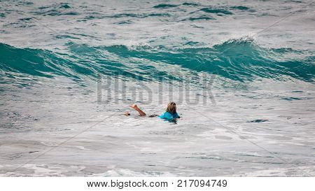 SUNSET BEACH HAWAII USA - DECEMBER 2, 2017: Competitive surfer at the 2017 Vans World Cup of Surfing competition at Sunset Beach on Oahu's scenic North Shore. This is the second of three surfing competitions and Conner Coffin took first place.