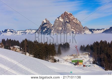 Stoos, Switzerland - 24 January, 2017: view in the village of Stoos in Switzerland in winter, summits of the Alps rising from sea of fog. Stoos is a ski resort village located in the Swiss canton of Schwyz.