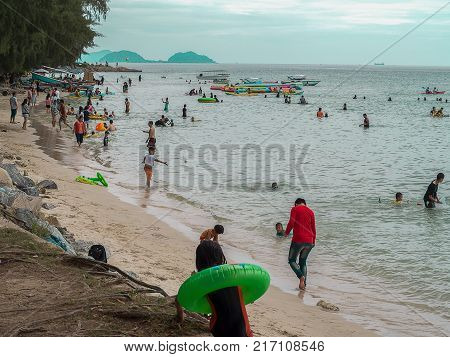 CHONBURI THAILAND - November 11 2017 View of tourists walking and playing on the beach at Nang Rum Beach (Sattahip) in Chonburi Thailand.