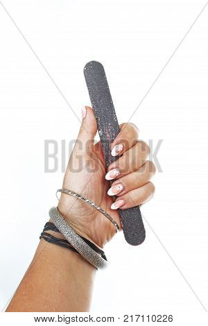 Woman hand holding nail filer on isolated white cutout background. Studio photo with studio lighting easy to use for every concept.