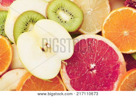 Fruit textures. Kiwi orange grapefruit lemon apple pear pomegranate mandarin fruits as background cover wallpaper. Colorful fresh fruits in rainbow colors. Beautiful delicious fruit wallpaper.